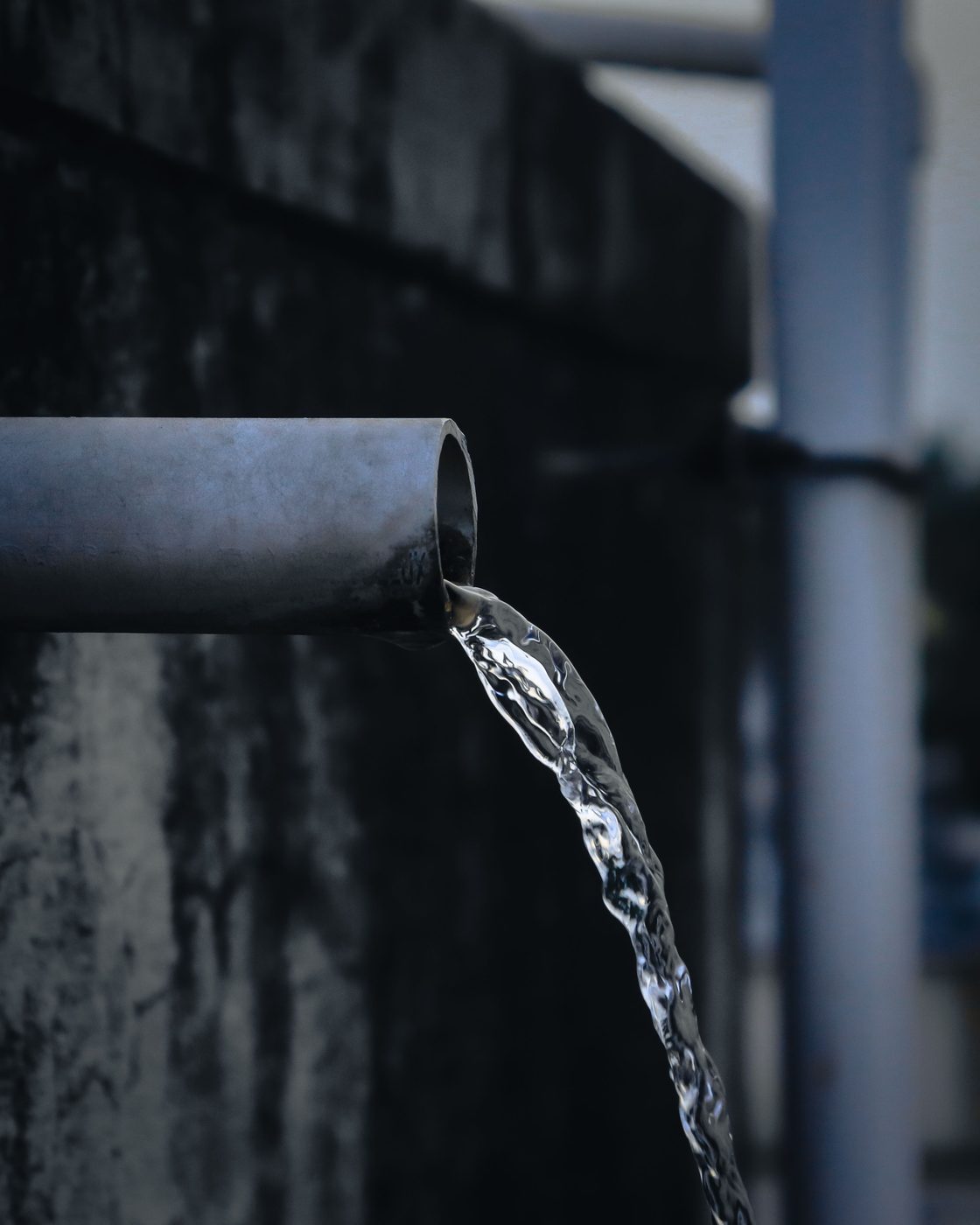Water flowing steadily from an outdoor pipe
