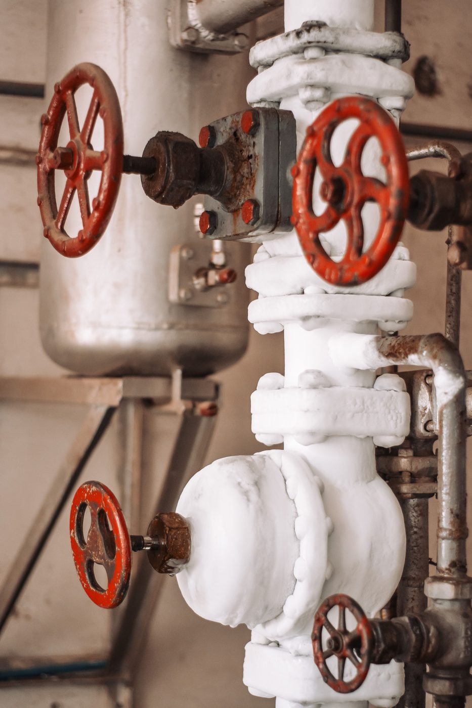 Close-up of industrial shut-off valves and piping
